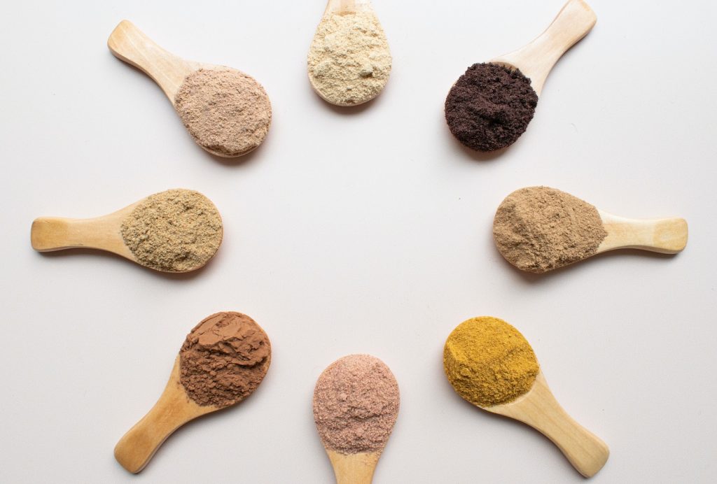 six different types of powdered spoons arranged in a circle